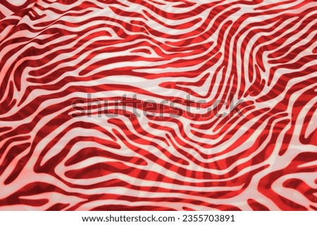 Red and white stripes, bends - a pattern on the fabric as a background texture. Animal abstract background.