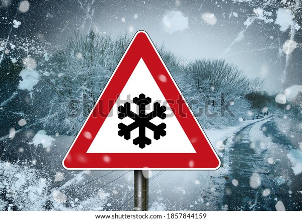 Red and white\
traffic sign with snowflake, caution winter tyres and winterreifen\
in front of a winterly\
scene