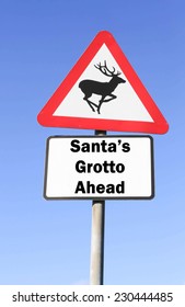 Red And White Triangular Road Sign Indicating The Santa's Grotto Ahead