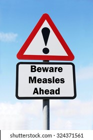 Red And White Triangular Road Sign With Warning To Beware Of Measles Ahead Concept Against A Partly Cloudy Sky Background