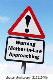 Red And White Triangular Warning Road Sign With A Warning Of Mother In Law Approaching Concept Against A Partly Cloudy Sky Background