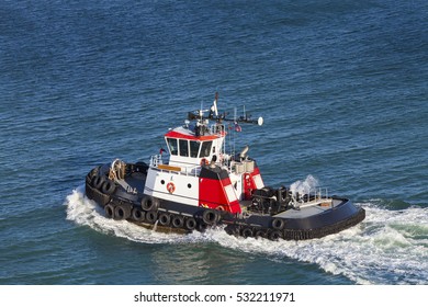 Red And White Tug Boat On The Open Ocean From Above.