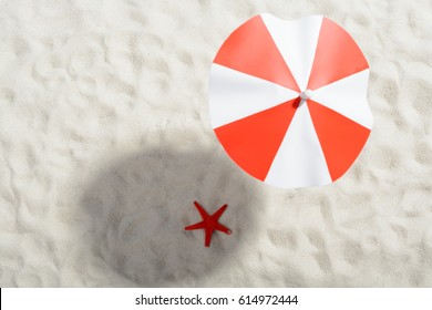 Red And White Umbrella On The Beach: Top View