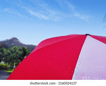 A Red White Umbrella Under Blue Sky