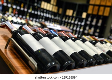 Red and white wine in bottles in wine shop