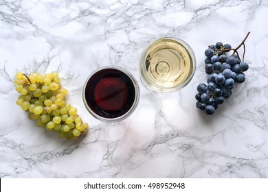 Red And White Wine In The Glass On Marble Table. Celebration Scene. Top View. Cheers.