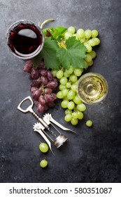 Red And White Wine Glasses And Grape Over Stone Table. Top View