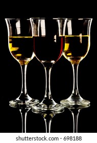 Red And White Wine In Three Glasses, Black Background