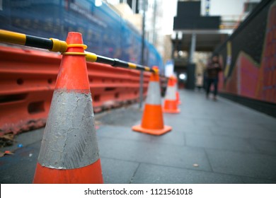 Red And White Witches Hat Cone Traffic Warning Signage Barrier Applying On Busy Street Downtown On Pedestrian Footpath, Road Under Construction In Sydney City CBD,  Australia 