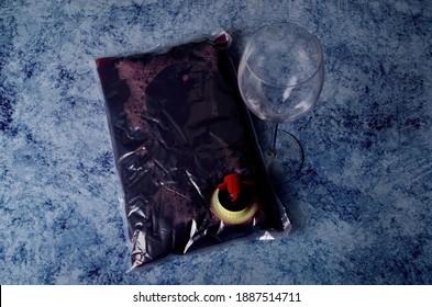 Red Wine In A 1.5 Litre Plastic Bag On Blue Stone Background
