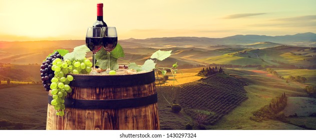 Red Wine With Barrel On Vineyard In Green Tuscany. Italy 