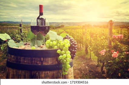 Red Wine With Barrel On Vineyard In Green Tuscany, Italy