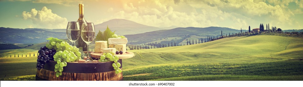 Red Wine With Barrel On Vineyard In Green Tuscany, Italy