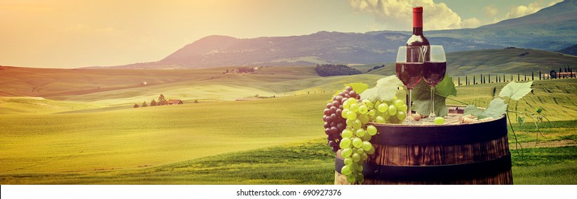 Red Wine With Barrel On Vineyard In Green Tuscany, Italy