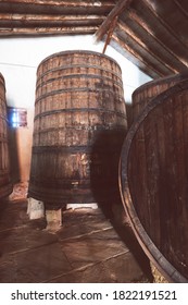 Red Wine Barrels Stacked In The Old Cellar Of The Vinery In Spain, Alicante. Toned Photo