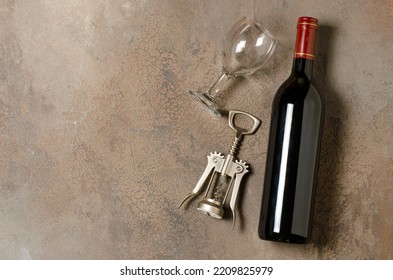 Red Wine In A Bottle. Brown Concrete Background. Flat Lay. Copy Space.