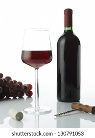 Red wine bottle and glass with grape, isolated on white background