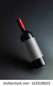 Red Wine Bottle Mockup With White Label On Black Background.