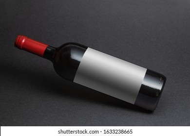 Red Wine Bottle Mockup With White Label On Black Background.