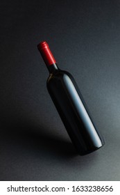 Red Wine Bottle Mockup Without Label On Black Background.