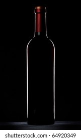 Red Wine Bottle Silhouette Over Black Background