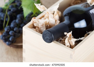 Red Wine Bottle In Wooden Box