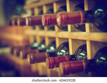 Red Wine Bottles Stacked On Wooden Racks