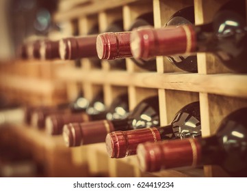 Red Wine Bottles Stacked On Wooden Racks