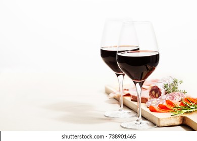 Red wine and charcuterie assortment on the board - Powered by Shutterstock