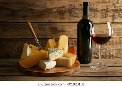 Red Wine And Cheeseboard On Wooden Background