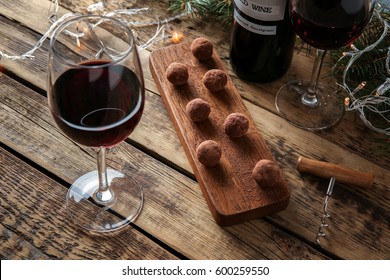 Red Wine, Chocolate Dessert And Christmas Decorations On Wooden Table