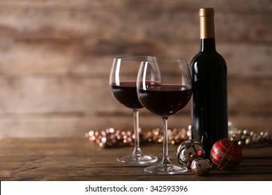 Red Wine And Christmas Ornaments On Wooden Table On Wooden Background