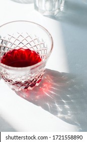 Red Wine In A Glass. Beautiful Reflections From Glass On A Table. Natural Light. Overhead View.