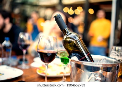 Red Wine Glass And Bottle With Ice Bucket On Valentines Day On Romantic Table