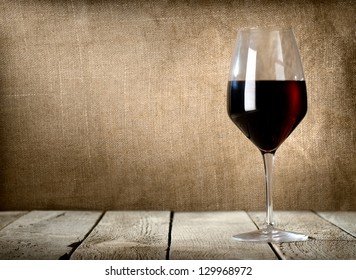 Red Wine Glass On The Wooden Table