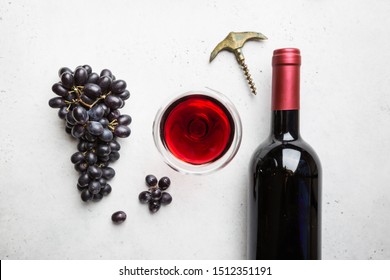 Red Wine In A Glass And Ripe Grapes On White Background, Top View