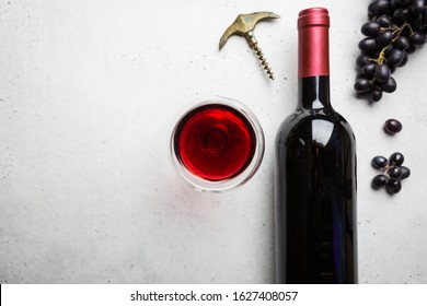 Red Wine In A Glass And Ripe Grapes On White Background, Top View