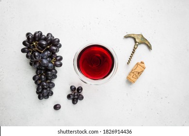 Red Wine In A Glass And Ripe Grapes On White Background, Top View