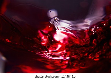 Red Wine On A Black Background , Abstract Splashing.