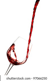 Red wine poured in a glass isolated on white.