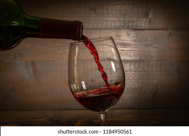 Red Wine Pouring Into A  Wineglass From A Bottel