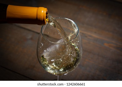 Red Wine Pouring Into A  Wineglass From A Bottel