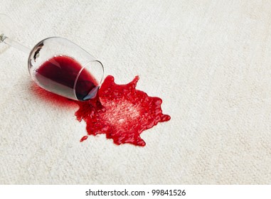 red wine is spilled on a carpet. reverse glass and all related