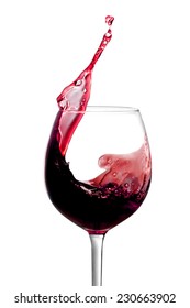 Red wine is splashing out of a wine glass