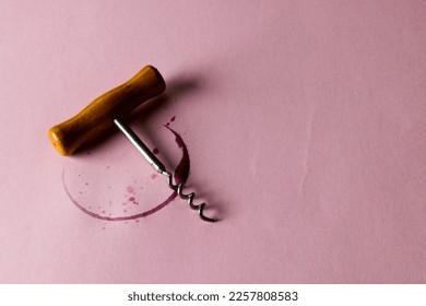 Red wine stain and corkscrew on pink background, with copy space. Wine week, drink and celebration concept. - Powered by Shutterstock