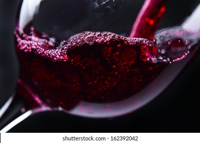  Red Wine In Wineglass On  Black Background