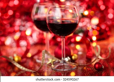 Red Wine In Wineglasses  Against Holiday Lights Background.