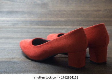 Red women highheel shoes on wooden floor
