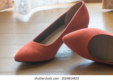 Red women highheel shoes on wooden floor