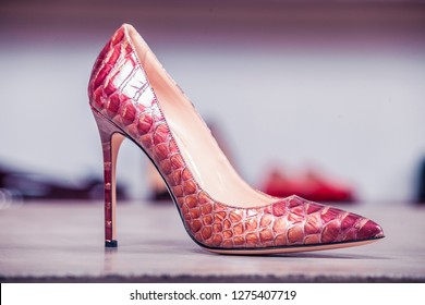 Red Women's Leather High-heeled Shoes On The Table In A Shoe Store